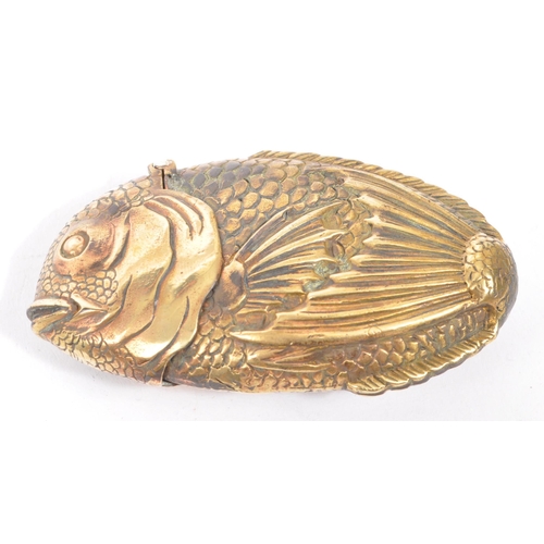 232 - A vintage 20th century brass metal vesta case in the form of an angel fish. With the head being the ... 