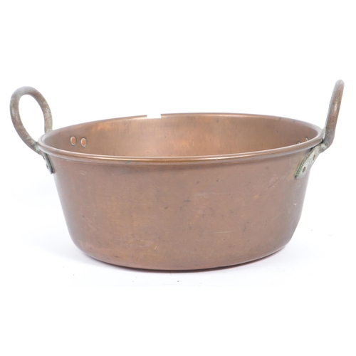 234 - An early 20th century circa 1920s copper tazza, alongside a collection of large brass pans / cooking... 