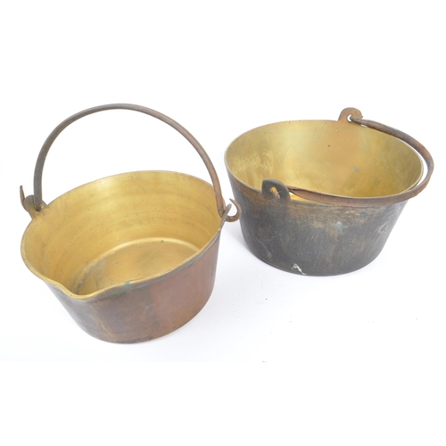 234 - An early 20th century circa 1920s copper tazza, alongside a collection of large brass pans / cooking... 