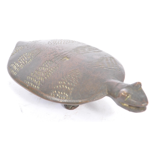 251 - A 20th century Asian bronze turtle figure. The figure raised on four legs, with engraved decoration ... 