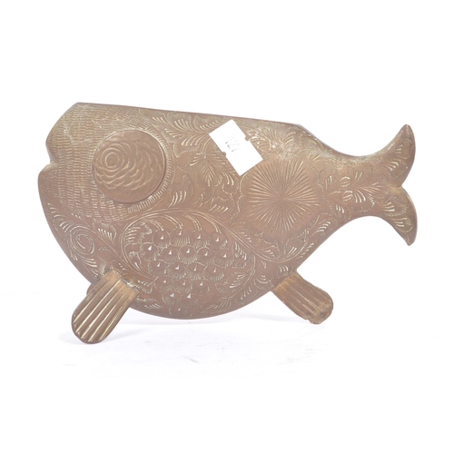 253 - An early 20th century engraved brass fish vase ornament. The fish having a rounded body, raised on f... 