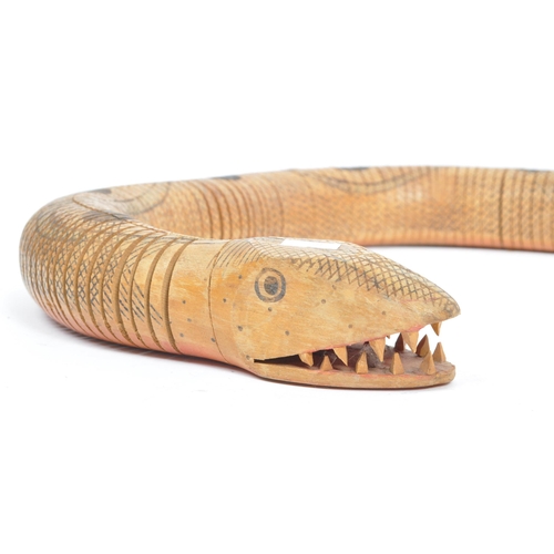 254 - A vintage 20th century painted wooden articulated snake figure. The figure in the form of a snake wi... 