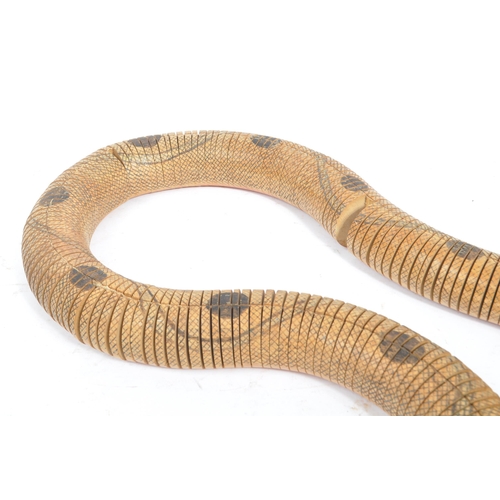 254 - A vintage 20th century painted wooden articulated snake figure. The figure in the form of a snake wi... 