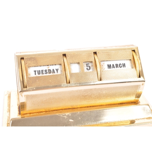 264 - A mid 20th century gilt metal desktop perpetual calendar. The calendar raised on a stepped base, hav... 