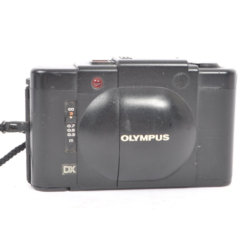 271 - Olympus XA - Two late 20th century Olympus XA range 35mm viewfinder scale focusing compact cameras. ... 