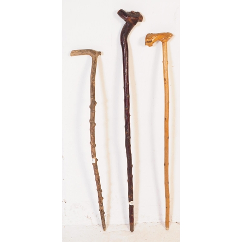 293 - A collection of early 20th century and later wood walking stick / swagger canes. Five in total, two ... 