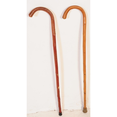 293 - A collection of early 20th century and later wood walking stick / swagger canes. Five in total, two ... 