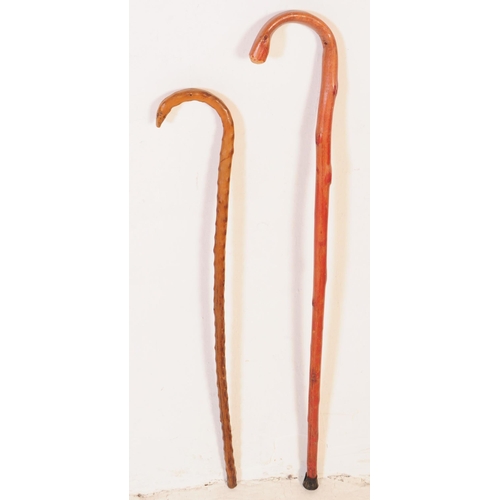 294 - A collection of vintage 20th century walking stick / swagger canes. Of wood construction, having she... 