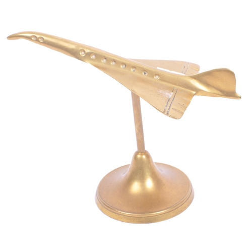 295 - A collection of 20th century decorative curios. The collection to include a brass airplane ornament ... 