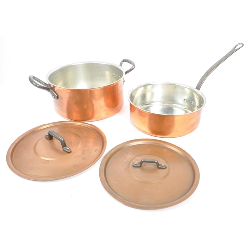 303 - A collection of 20th century copper zinc cookware, alongside a copper brass ewer. The collection to ... 