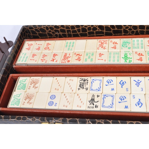 304 - A 20th century Chinese mahjong game set in a crocodile skin manner case. The set including two boxes... 