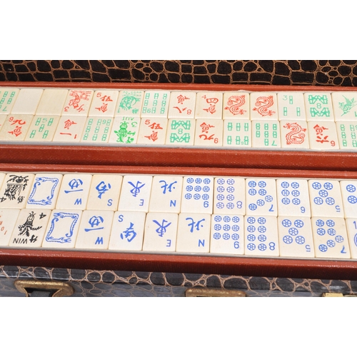 304 - A 20th century Chinese mahjong game set in a crocodile skin manner case. The set including two boxes... 