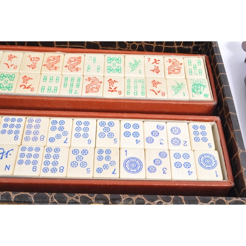 304 - A 20th century Chinese mahjong game set in a crocodile skin manner case. The set including two boxes... 