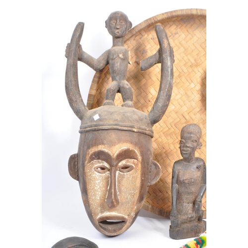 305 - A collection of mid 20th century carved tribal African items. Comprising of carved wall masks of var... 