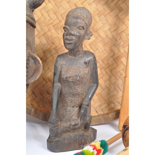 305 - A collection of mid 20th century carved tribal African items. Comprising of carved wall masks of var... 