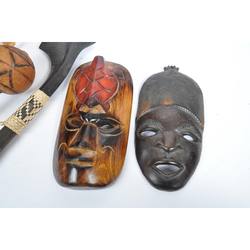 305 - A collection of mid 20th century carved tribal African items. Comprising of carved wall masks of var... 