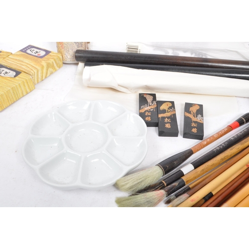 308 - A collection of Chinese brush painting art supplies, to include; a large collection of brushes, a tr... 