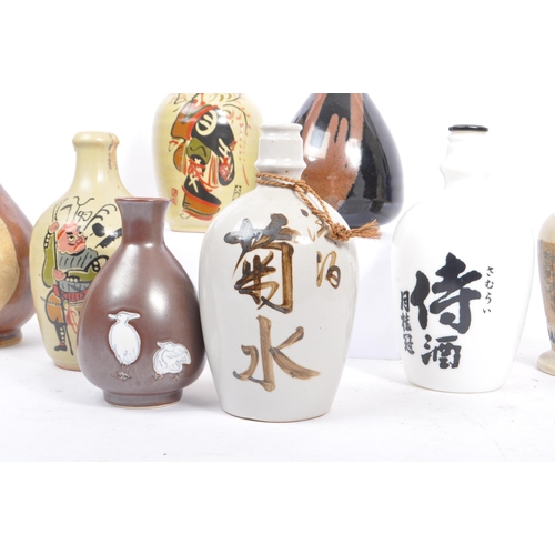 31 - A collection of vintage 20th century Japanese sake bottles and vases. Of circular form and ceramic p... 