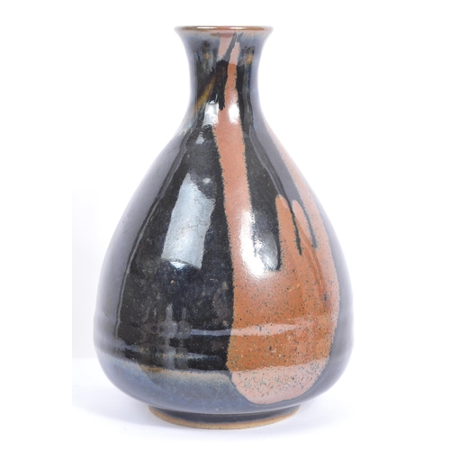 31 - A collection of vintage 20th century Japanese sake bottles and vases. Of circular form and ceramic p... 