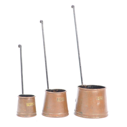 310 - A collection of 20th century copper shop measures / cups. The collection to include a series of thre... 