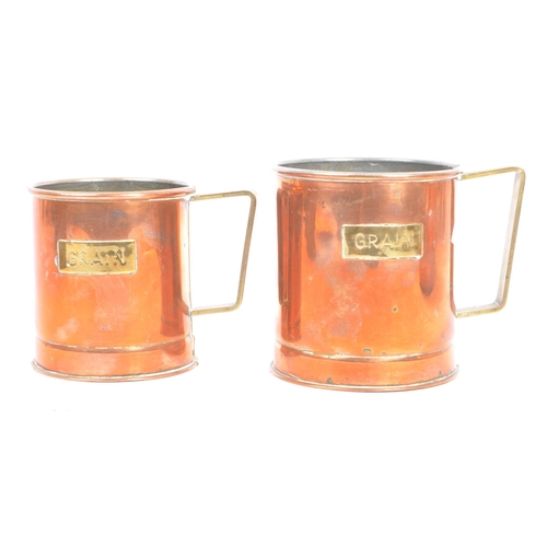 310 - A collection of 20th century copper shop measures / cups. The collection to include a series of thre... 