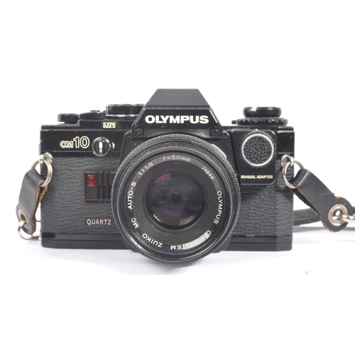 318 - Olympus - A late 20th century circa 1980s OM10 Quartz 35mm SLR camera with lenses and accessories. T... 