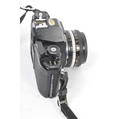 322 - Nikon - Two 20th century 35mm SLR film cameras. The lot consisting of a Nikon EM 35mm SLR camera wit... 