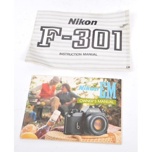 322 - Nikon - Two 20th century 35mm SLR film cameras. The lot consisting of a Nikon EM 35mm SLR camera wit... 