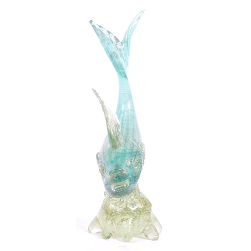 33 - A mid 20th century Murano studio art glass fish. The fish resting atop a glass form in the manner of... 