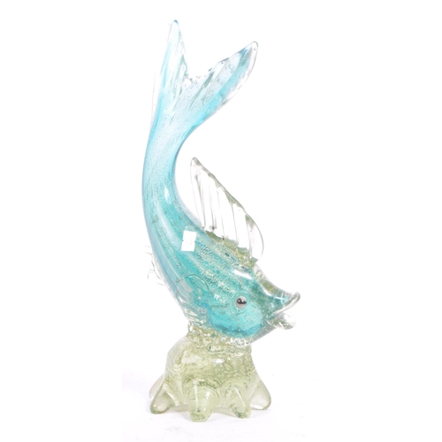 33 - A mid 20th century Murano studio art glass fish. The fish resting atop a glass form in the manner of... 