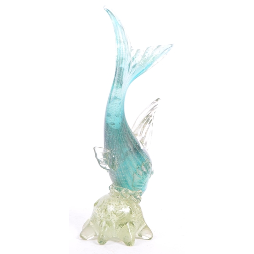 33 - A mid 20th century Murano studio art glass fish. The fish resting atop a glass form in the manner of... 