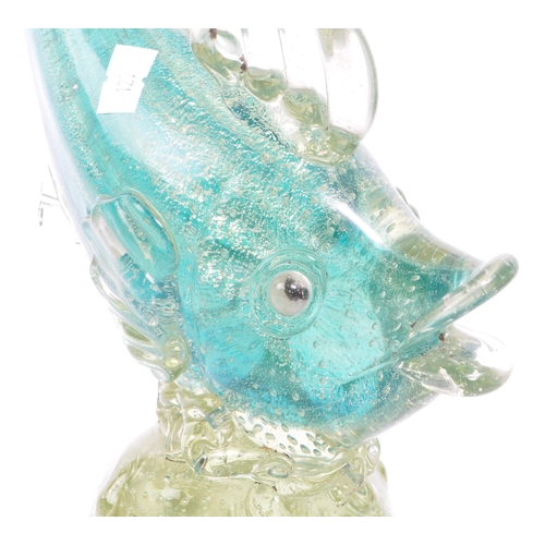 33 - A mid 20th century Murano studio art glass fish. The fish resting atop a glass form in the manner of... 