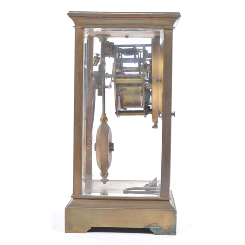 338 - A French eight day movement brass four glass mantel clock. Of rectangular form with white enamelled ... 