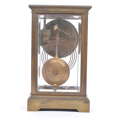 338 - A French eight day movement brass four glass mantel clock. Of rectangular form with white enamelled ... 