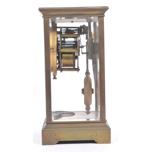 338 - A French eight day movement brass four glass mantel clock. Of rectangular form with white enamelled ... 