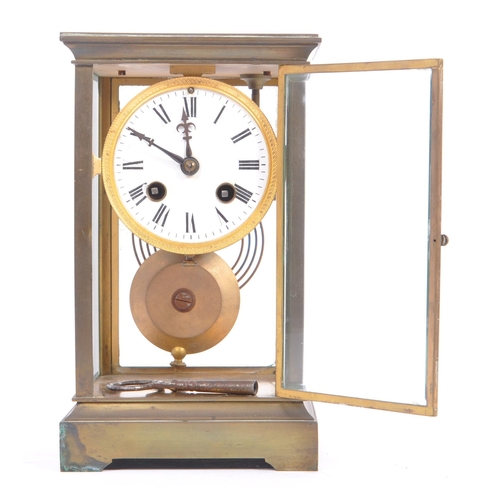 338 - A French eight day movement brass four glass mantel clock. Of rectangular form with white enamelled ... 