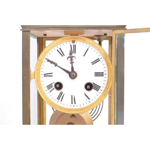 338 - A French eight day movement brass four glass mantel clock. Of rectangular form with white enamelled ... 