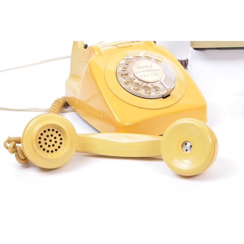 348 - A collection of three mid 20th century rotary dial telephones. The telephones each in a yellow, crea... 