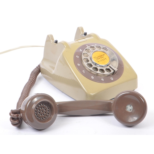 348 - A collection of three mid 20th century rotary dial telephones. The telephones each in a yellow, crea... 