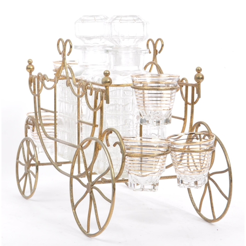 349 - A vintage four wheel wire liqueur decanter carriage cart. Frame to house two decanter bottles with o... 