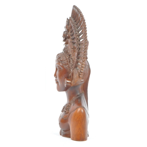 350 - A 20th century Balinese teak wood bust carving sculpture of a lady with ceremonial headdress. With i... 