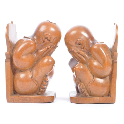 364 - A pair of Asian 20th century carved hardwood weeping Buddha bookends. The bookends in the form of a ... 