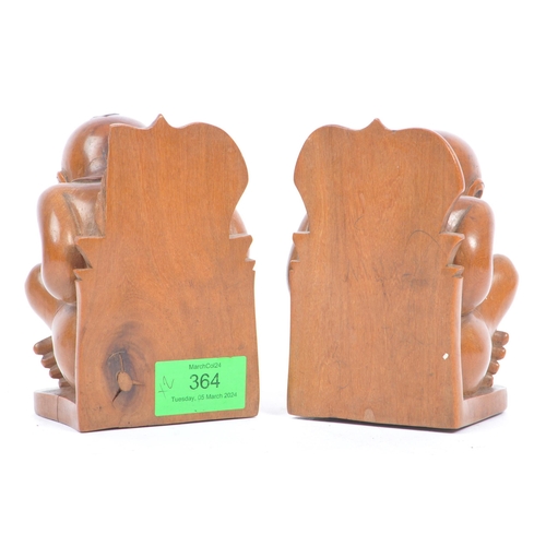 364 - A pair of Asian 20th century carved hardwood weeping Buddha bookends. The bookends in the form of a ... 