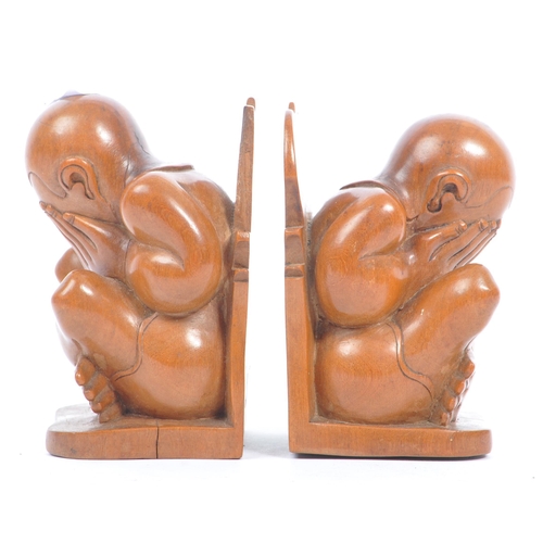 364 - A pair of Asian 20th century carved hardwood weeping Buddha bookends. The bookends in the form of a ... 