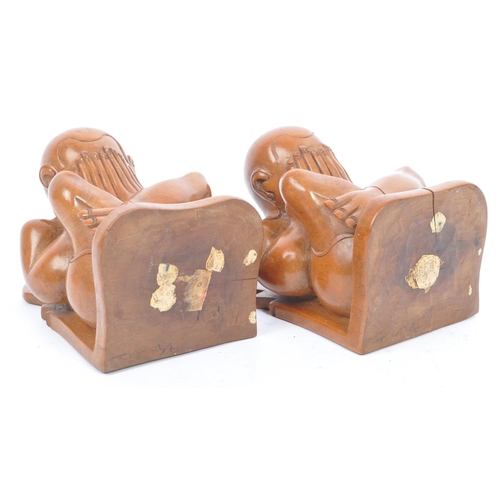 364 - A pair of Asian 20th century carved hardwood weeping Buddha bookends. The bookends in the form of a ... 