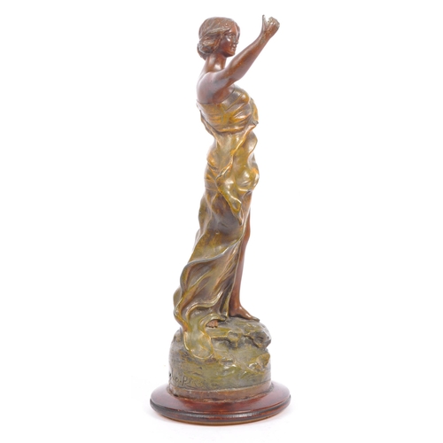 369 - A 20th century gold painted bronze female figure. The figure positioned atop a rock, with arm outstr... 