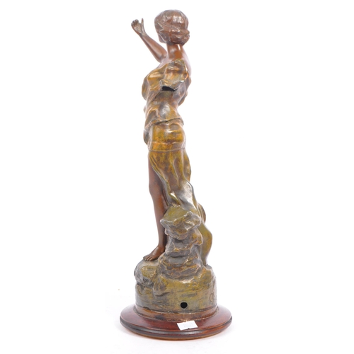 369 - A 20th century gold painted bronze female figure. The figure positioned atop a rock, with arm outstr... 