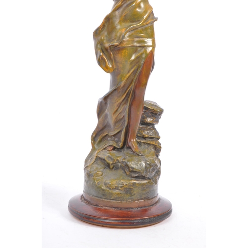 369 - A 20th century gold painted bronze female figure. The figure positioned atop a rock, with arm outstr... 