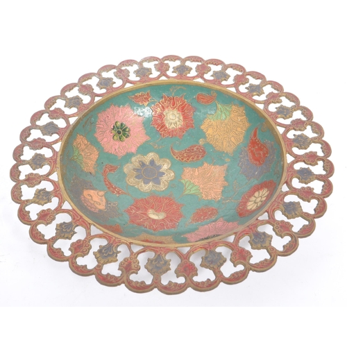 371 - A vintage 20th century Indian brass enamelled charger. Together with two pierced bowls. Having polyc... 