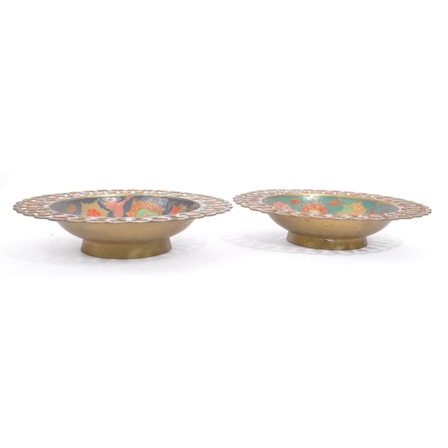 371 - A vintage 20th century Indian brass enamelled charger. Together with two pierced bowls. Having polyc... 